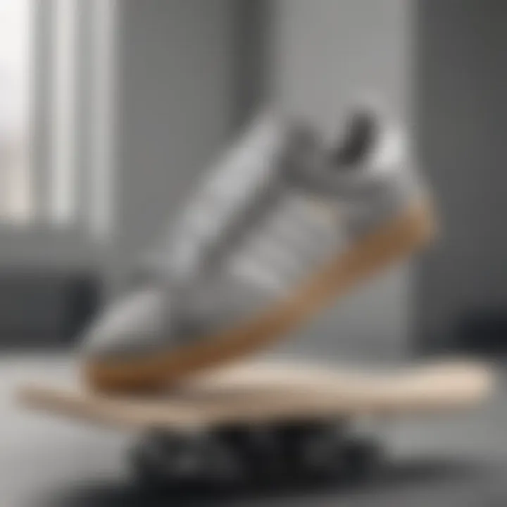 A collection of grey and white Adidas shoes displayed on a skateboard