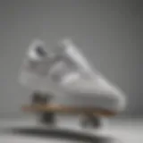 A stylish pair of grey and white Adidas sneakers on a skateboard