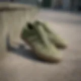 Adidas army green skate shoes displayed on a concrete surface