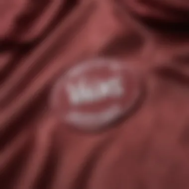 Close-up of the Vans logo on the Burgundy Windbreaker, highlighting branding.